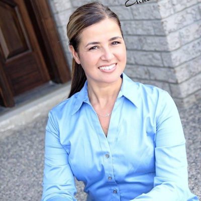 IMG_4405 A woman in blue shirt sitting on steps.