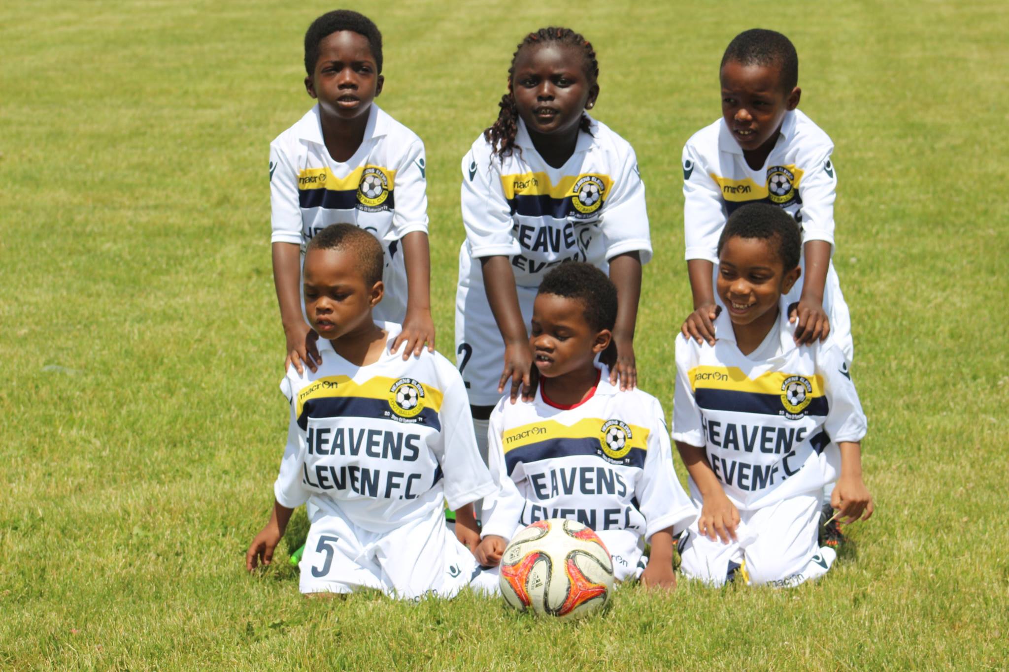 A group of young children in soccer uniforms.