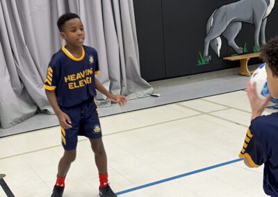 Young basketball player standing on the court ready to play.
