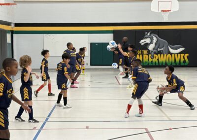Youth basketball game with players actively moving on the court.