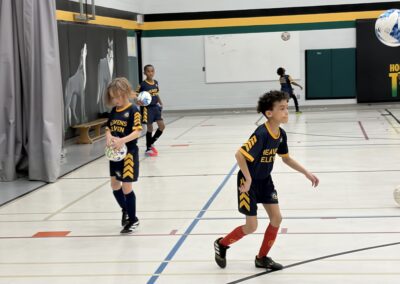 Children playing basketball in a gymnasium.