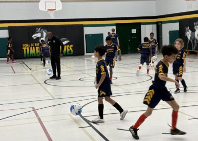 Youth basketball players warming up on an indoor court.