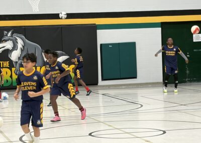 Youth basketball game in progress with players actively dribbling and defending.