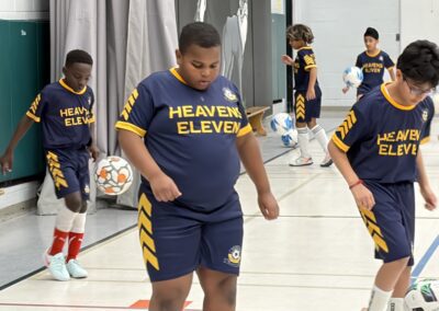 Young athletes in matching blue and yellow uniforms preparing for basketball.
