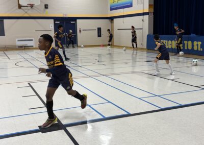 Children playing basketball in a gymnasium.