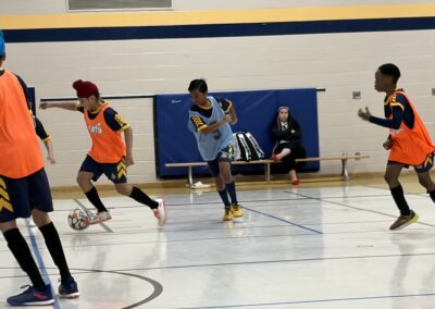 Two young basketball players in action on an indoor court.