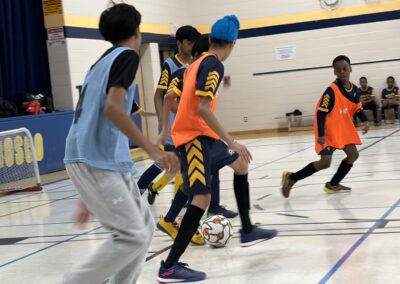 Young players compete in an indoor basketball game.