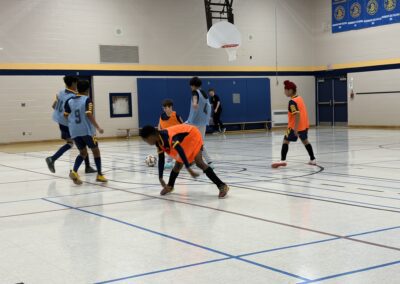 Youth basketball players in action during an indoor game.