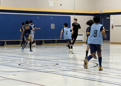 Youth basketball game in action inside a gymnasium.