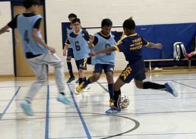 Youth basketball game with players competing intensely on court.