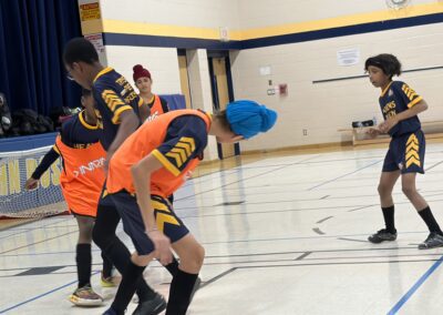 Children playing basketball in a gymnasium during a game.