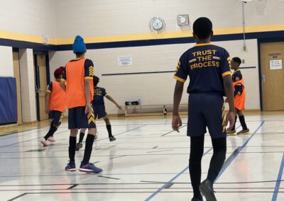 Youth basketball game in progress in a gymnasium.