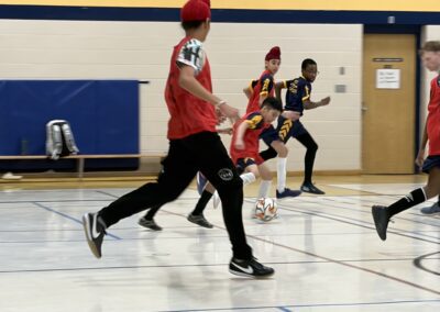 Players in a fast-paced indoor soccer game.