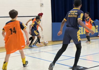 Youth basketball game in action, players focused on the ball.
