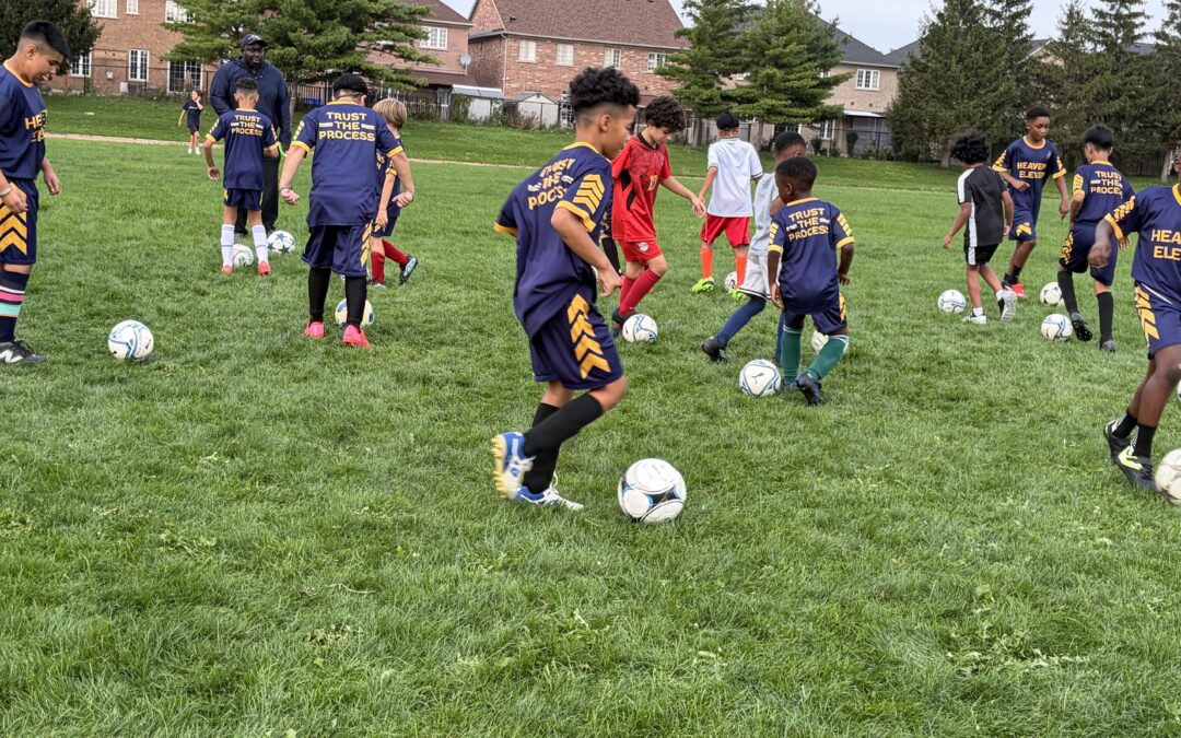 Youth soccer practice on grassy field.